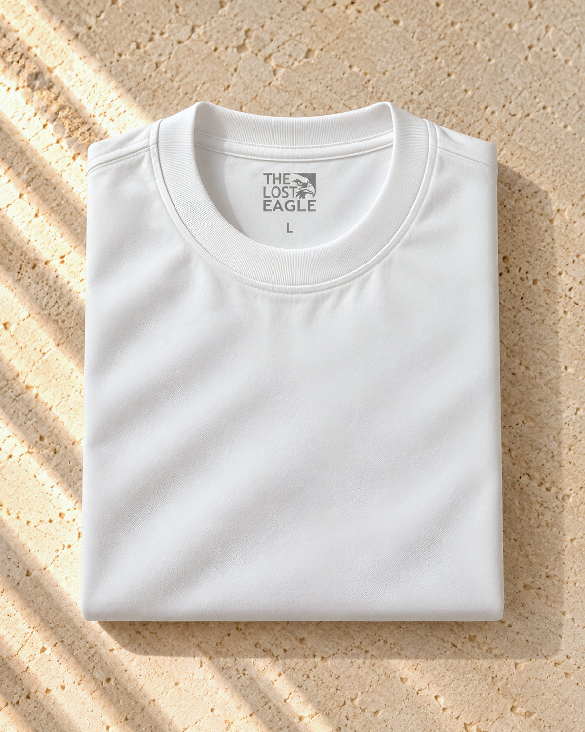 the signature tee in white, folded, printed neck label