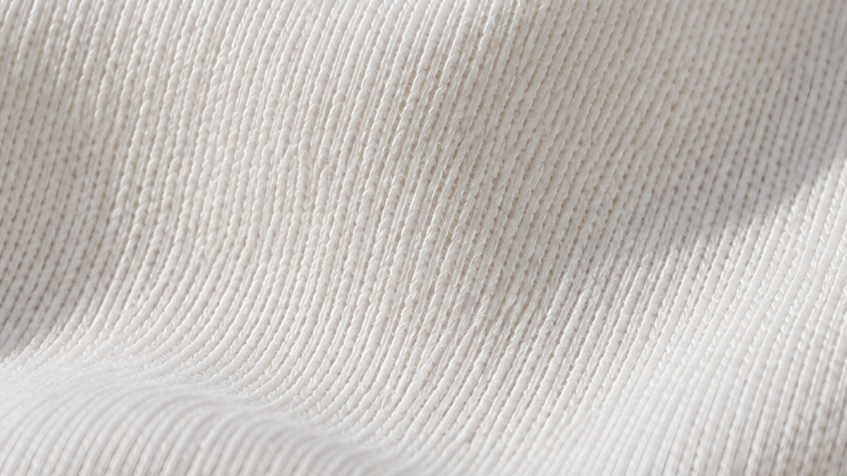 close-up of white cotton jersey knit in soft light