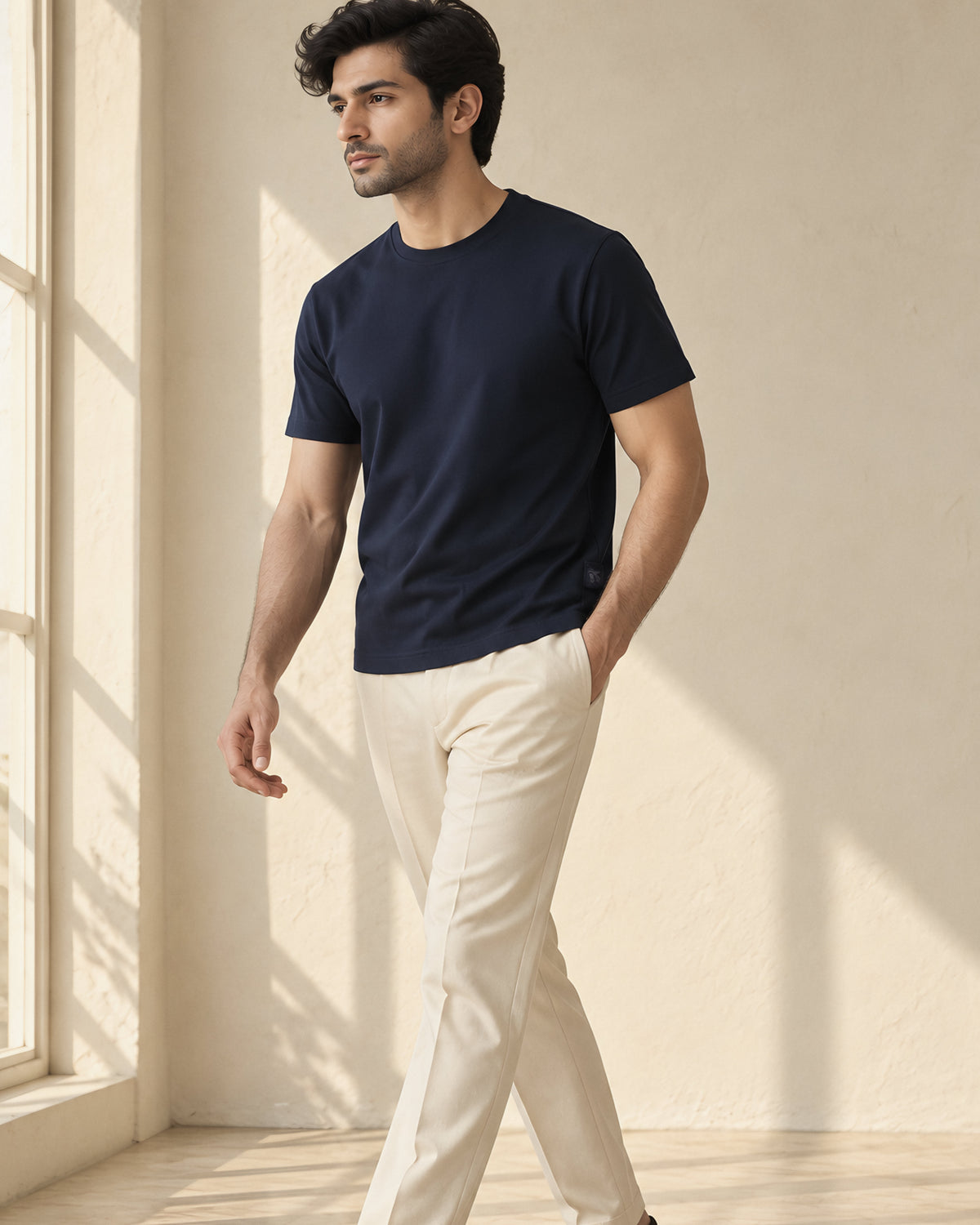 the signature tee in dark blue, walking by the window