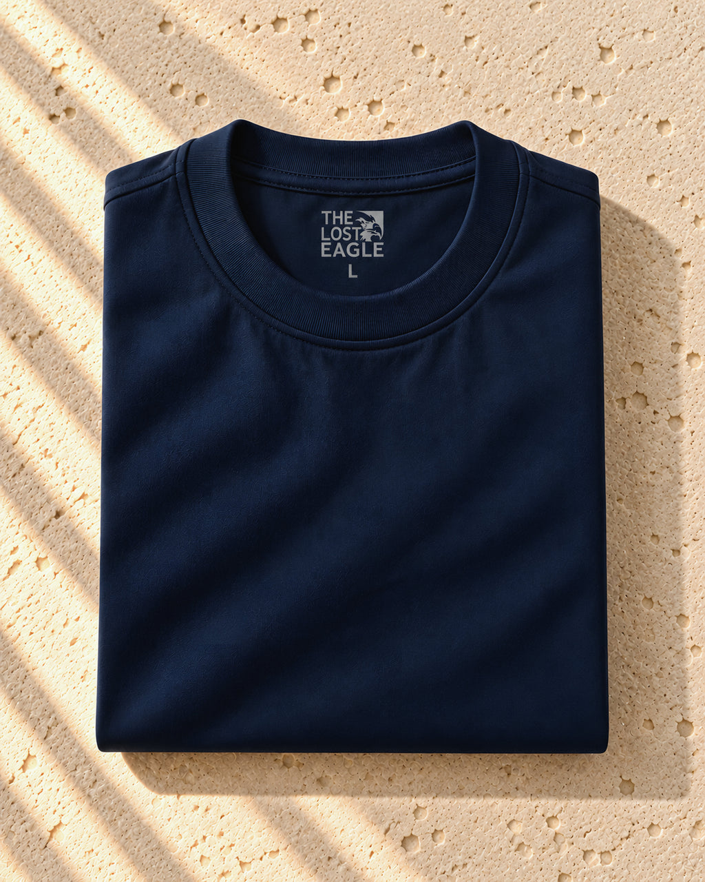 the signature tee in dark blue, folded, printed neck label