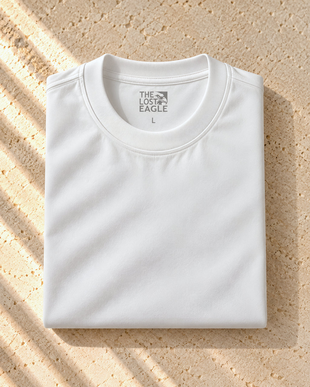 the signature tee in white, folded, printed neck label