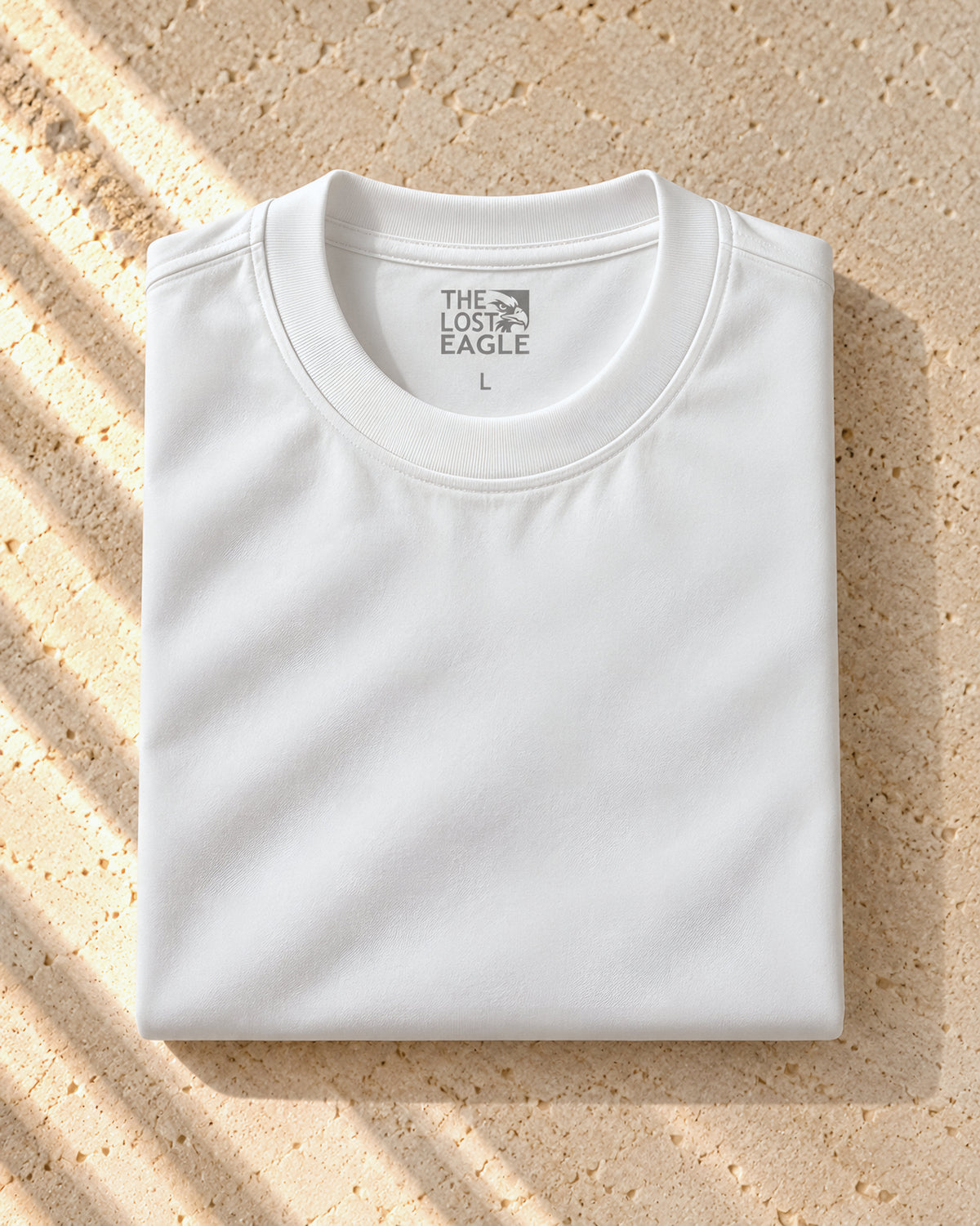 the signature tee in white, folded, printed neck label